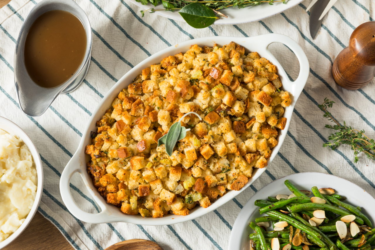 An overhead shot of a simple poultry stuffing on a table with various side dishes