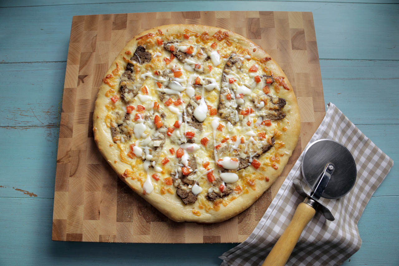 An East coast inspired donair pizza on a cutting board