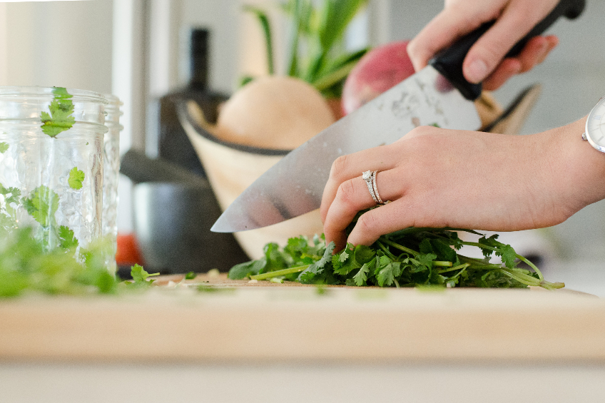 Cilantro being chopped on a cutting board