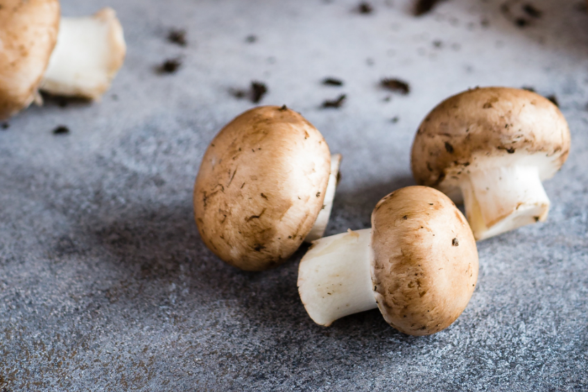 Button mushrooms on a marble surface