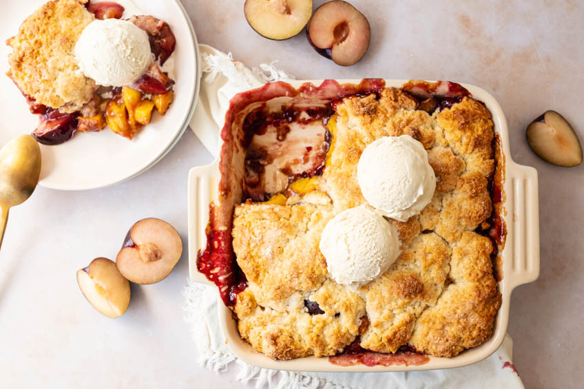 Peach plum cobbler topped with ice cream