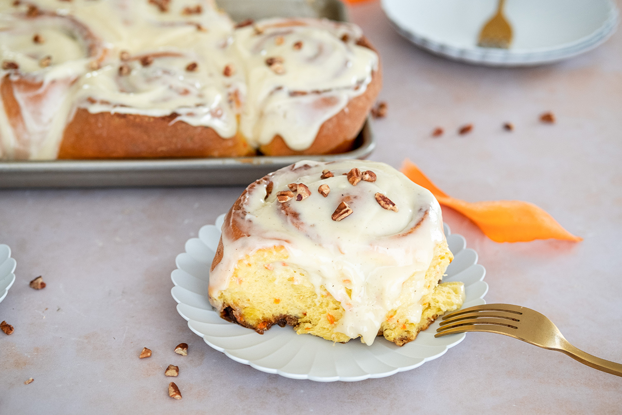 carrot cake cinnamon roll on a plate