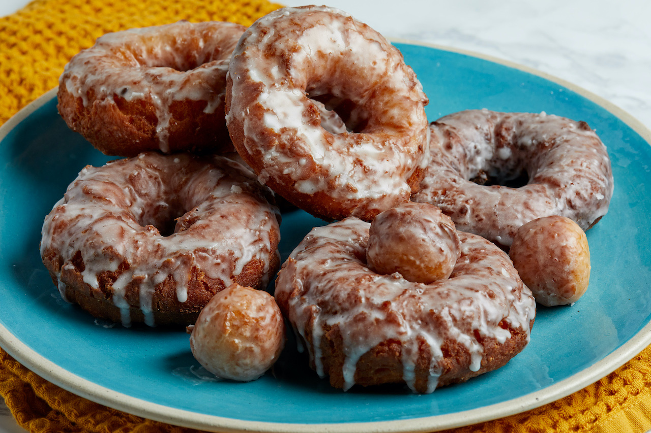 A plate of homemade old fashioned doughnuts with a glaze