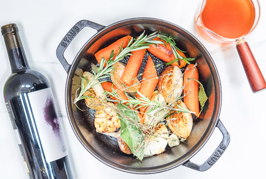 ingredients for slow cooker short ribs in a dutch oven