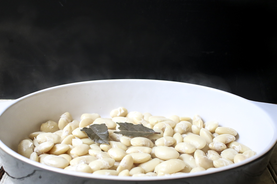 Greek beans steaming in a white casserole dish