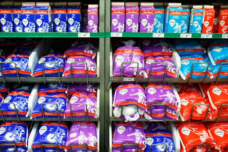 bagged milk in bags sitting on grocery store shelf