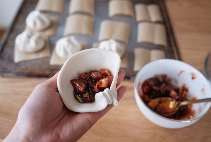 bao bun filling inside bao bun dough