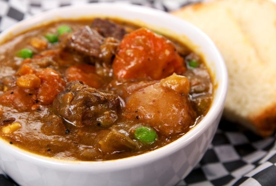 Buffalo stew in a boat next to bread