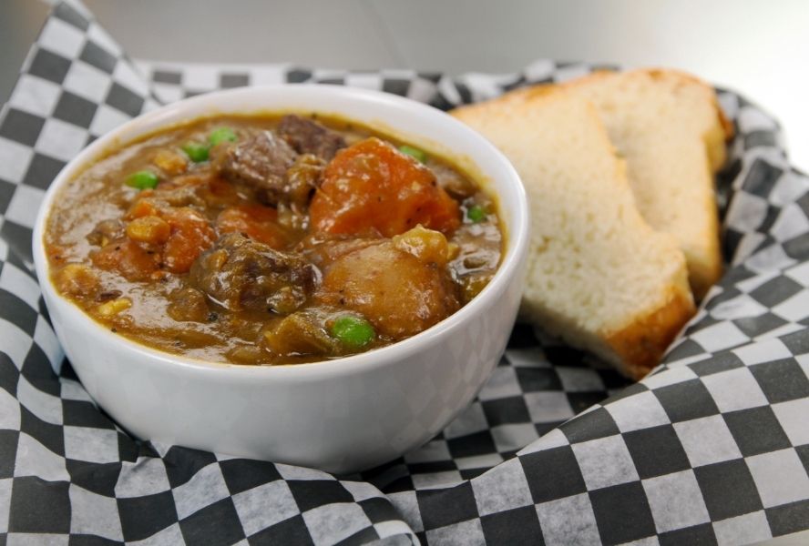 Buffalo stew in a boat next to bread