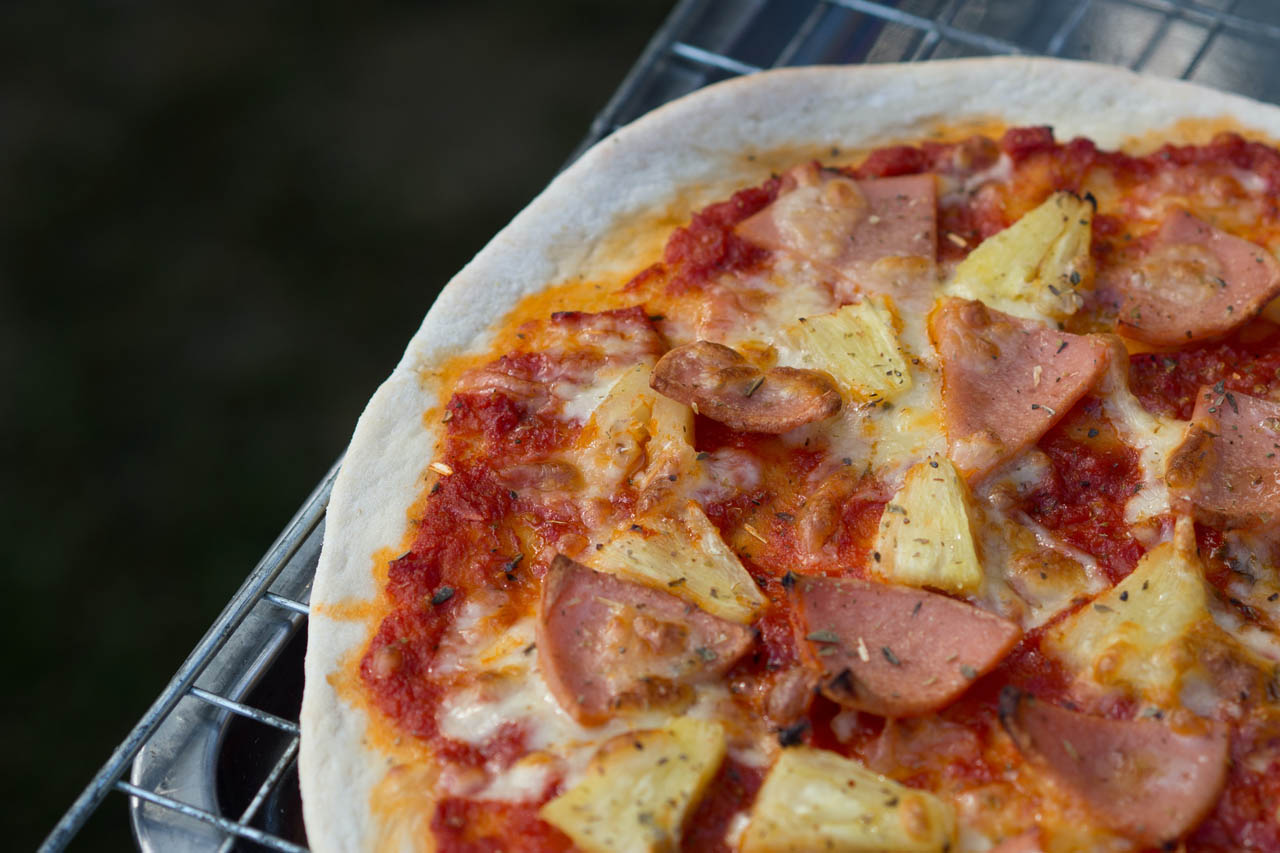 hawaiian pizza on a cooling rack