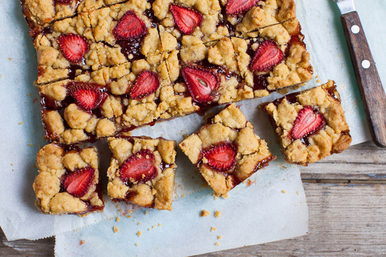 jammy strawberry shortbread bars, sliced and ready to serve