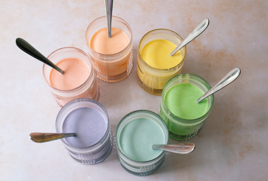 rainbow crepes batter separated by colour on a countertop