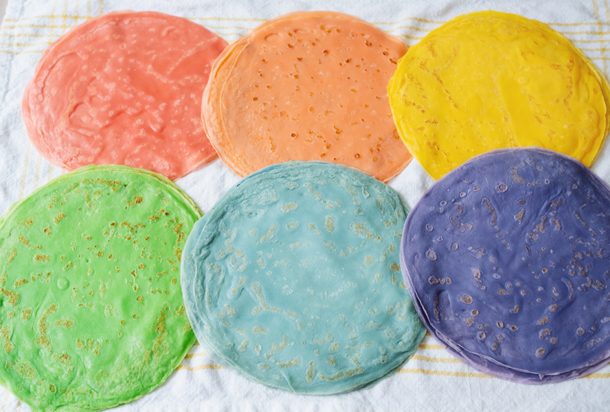 cooked rainbow crepes on a countertop