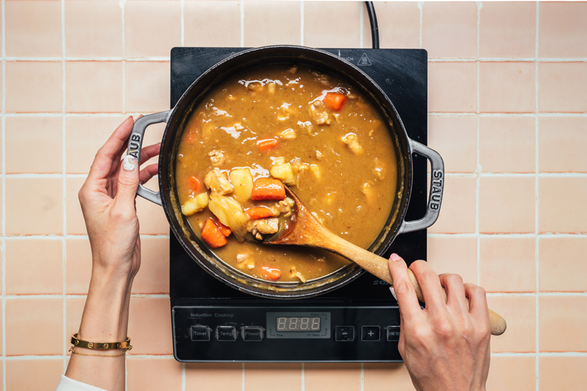 Japanese chicken curry with apples cooking on stovetop