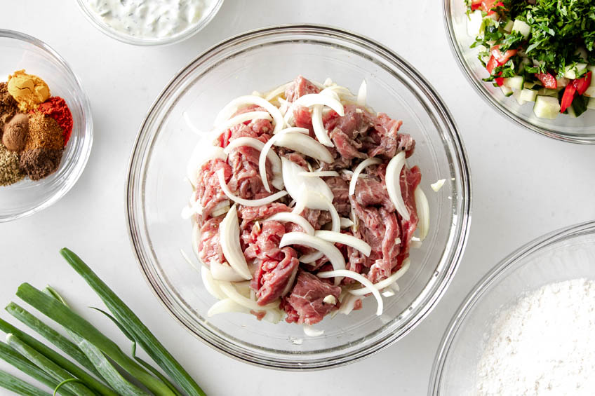 flank steak being marinated with shawarma seasoning