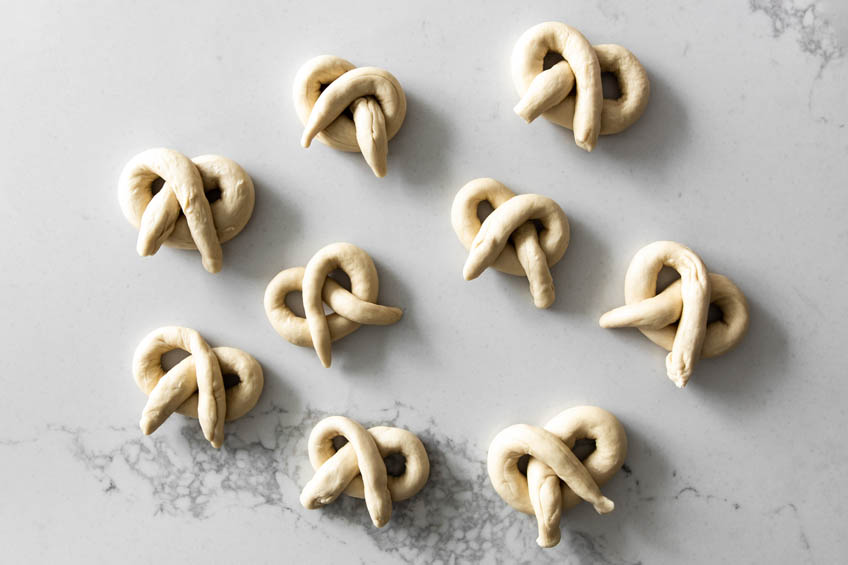 dough rolled into pretzels for pumpkin spice soft pretzels