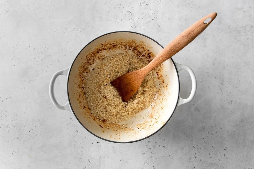 Risotto cooking in white pot