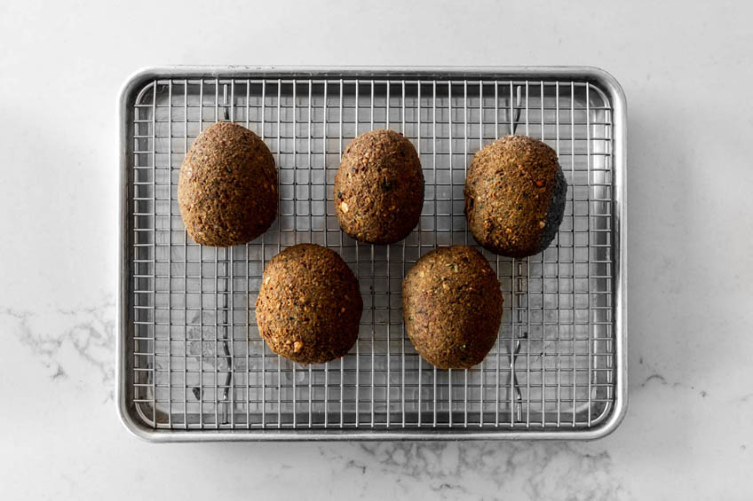 Fried Falafel Scotch Eggs on a cooling rack.