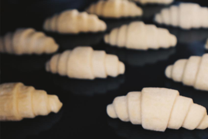 Unbaked Pillsbury Crescent Rolls on a baking sheet