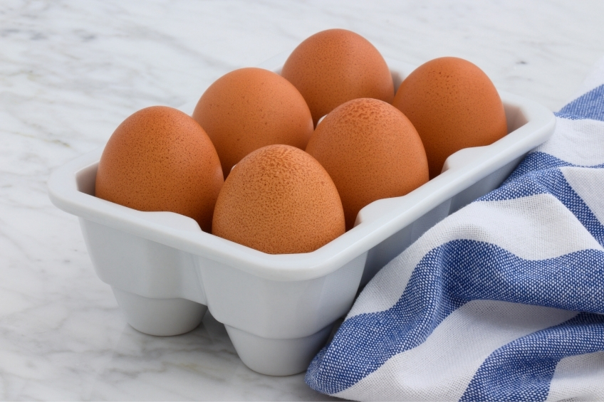 Brown eggs in a ceramic carton