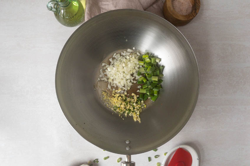 Ginger, onions and green onions in a wok