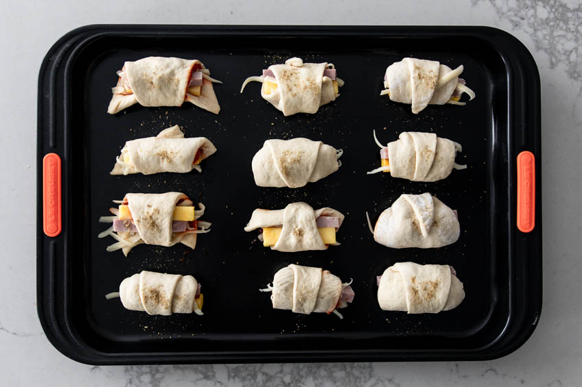 Hawaiian pigs in a blanket on a baking sheet