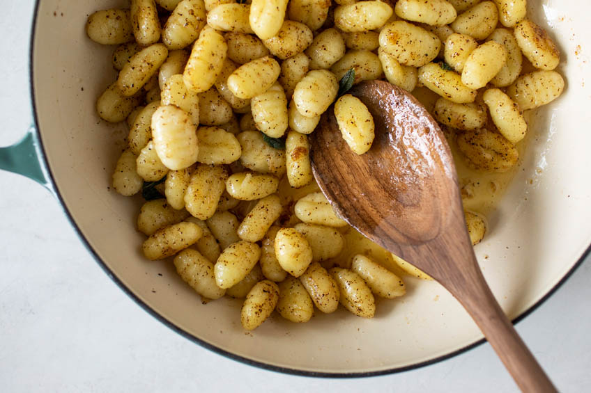 Gnocchi being tossed in brown butter sauce