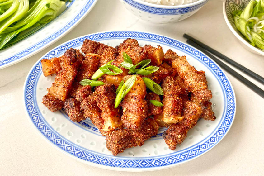 Air Fryer pork belly on a blue patterned plate