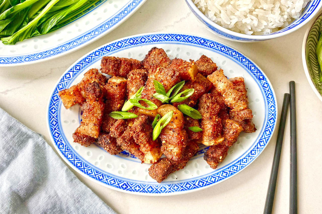 Air Fryer pork belly on a blue patterned plate