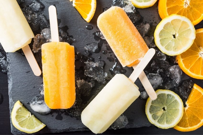 Citrus popsicles on a black background