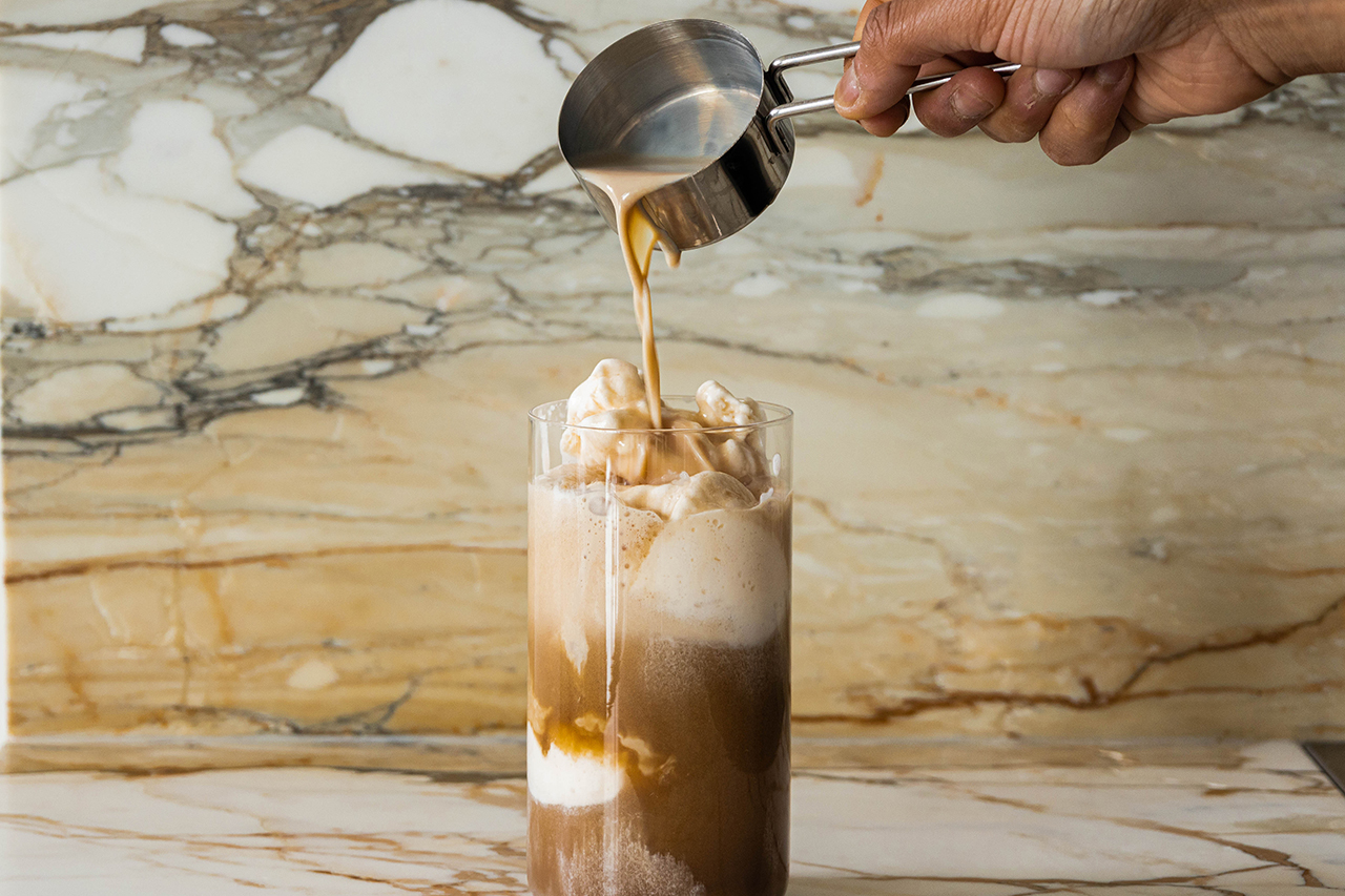 Pouring Baileys Irish Cream over Guinness and vanilla ice cream