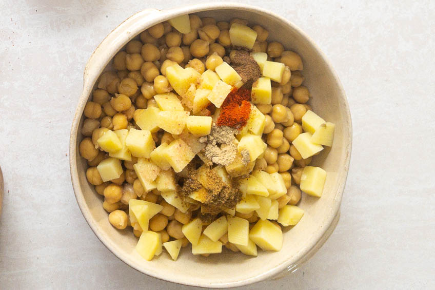 Potatoes, chickpeas and spices in a bowl