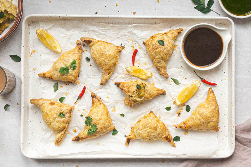 puff pastry samosas on a serving platter