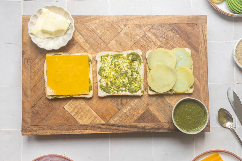 Bread topped with butter, chutney, cheese and potatoes