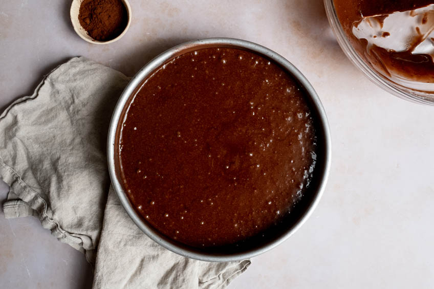 Chocolate olive oil cake batter in a cake pan