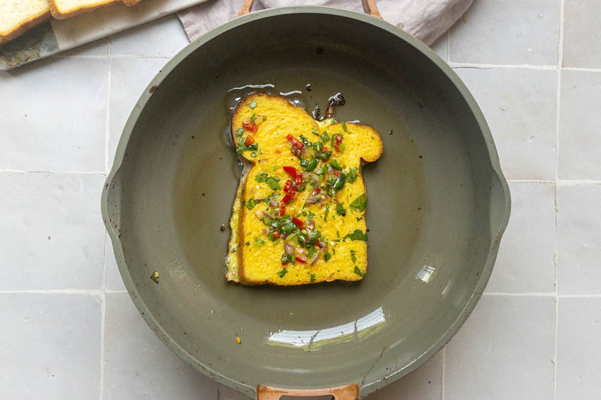 Masala toast being cooked in a frying pan