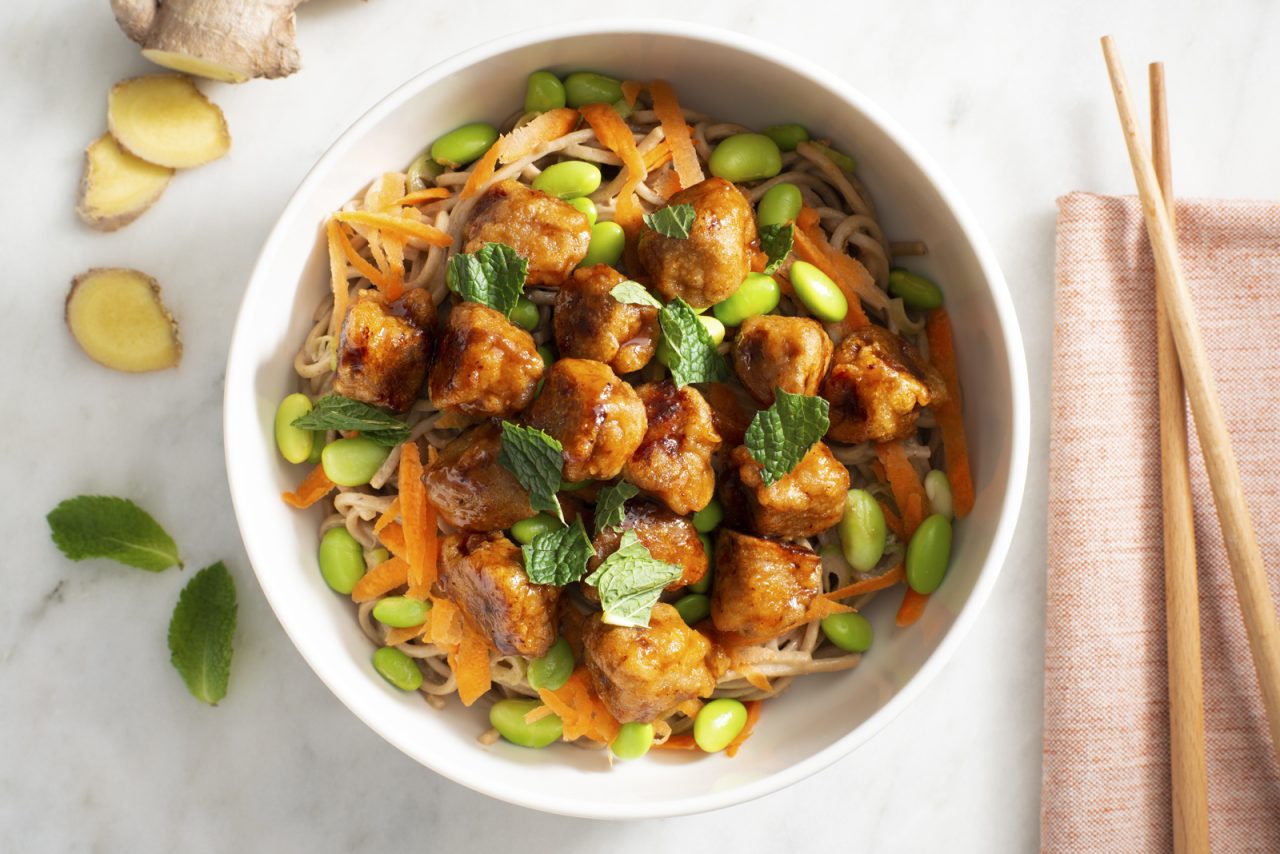 A noodle bowl made with Gardein Sweet and Sour Porkless Bites, edamame and soba noodles