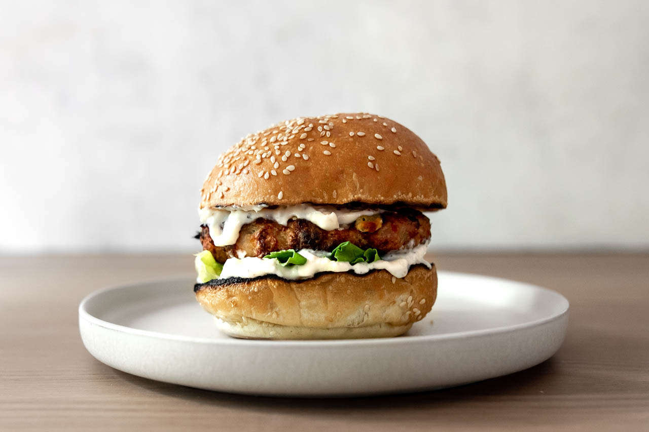 Chicken caesar salad burger on a plate