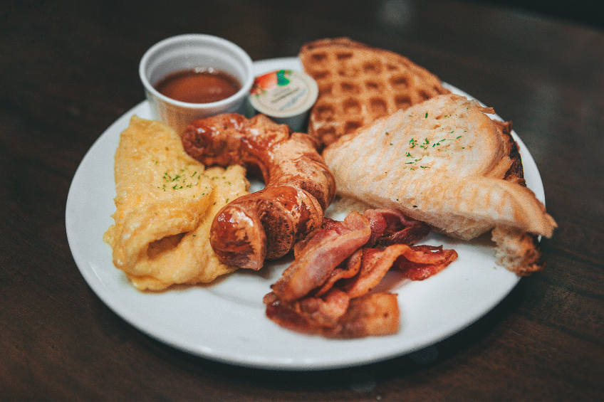 Classic diner breakfast with eggs, sausage, bacon and toast