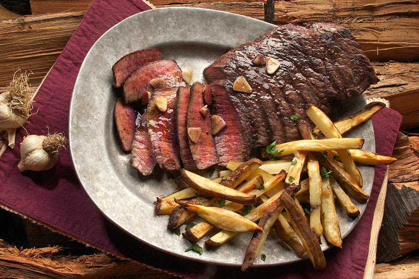 A steak dinner with fries