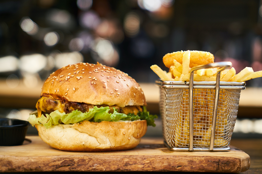 Burger and fries on a wooden board