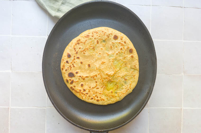 Crispy aloo paratha in a pan