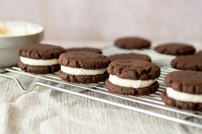 Chocolate sandwich cookies cooling on a wire rack