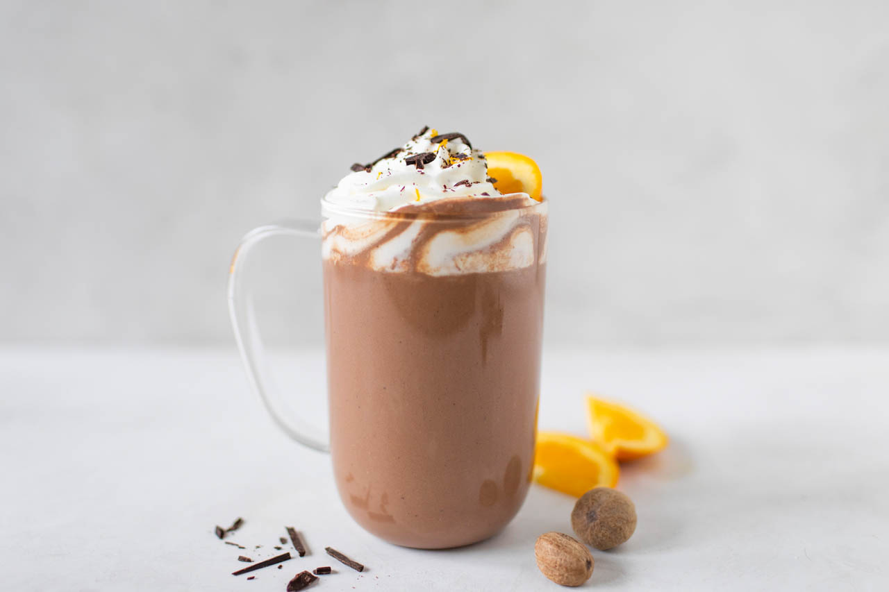 A glass mug of chocolate orange hot chocolate