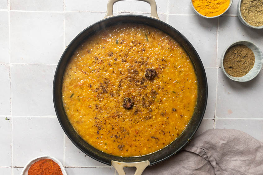 Daal sprinkled with garam masala in a skillet