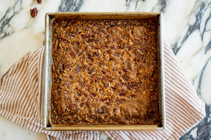 Brown butter maple pecan squares in a baking tray.