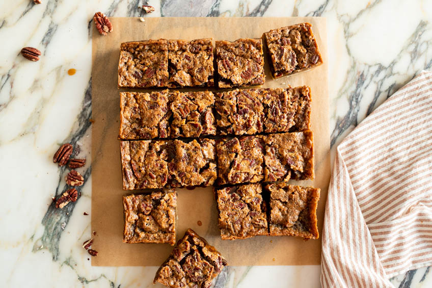 Brown butter maple pecan squares on parchment paper