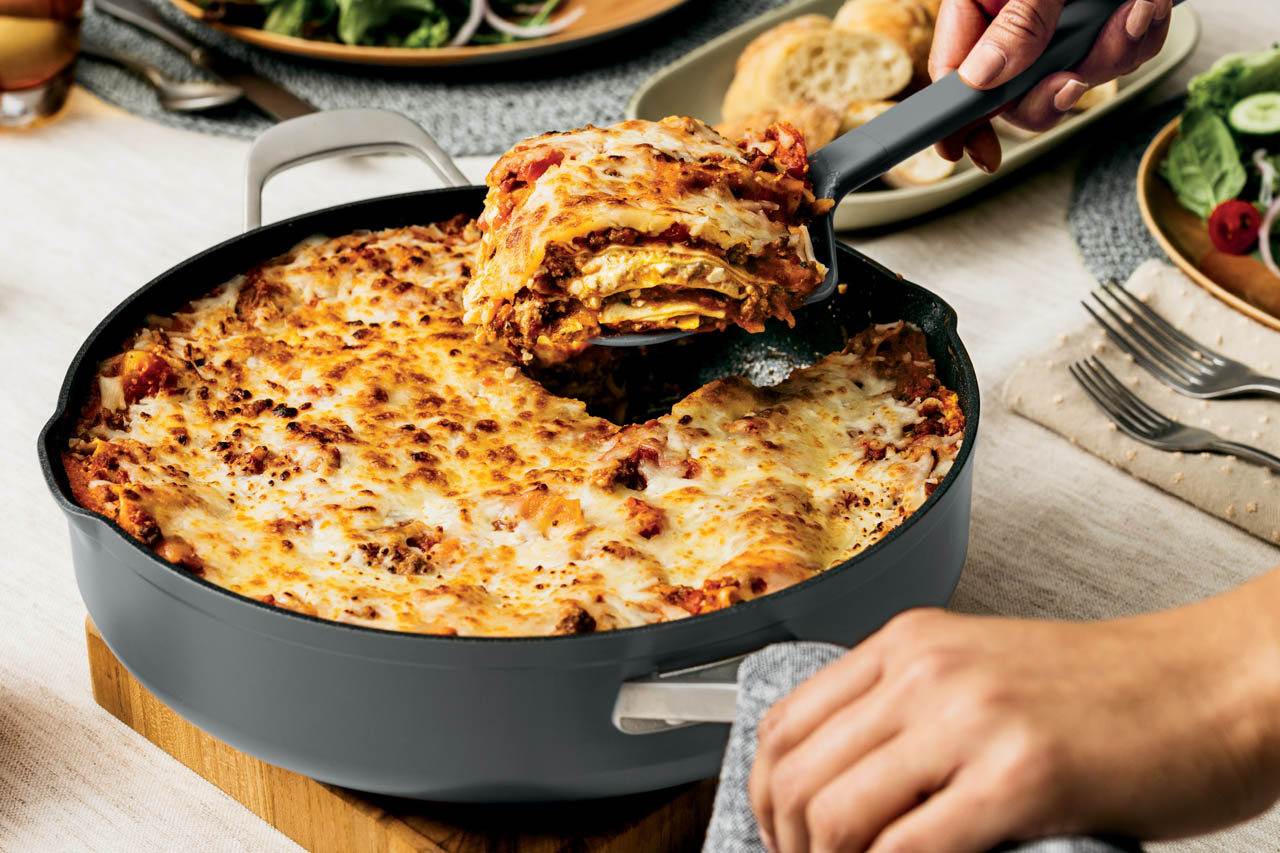 A closeup of lasagna being served out of the Ninja Foodi Possible Pan