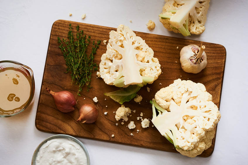 ingredients for a cauliflower soup on a cutting board