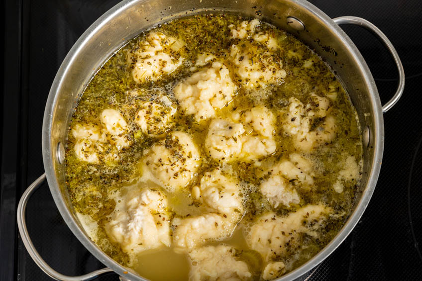 Acadian chicken fricot simmering in a pot